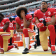 Eli Harold, Colin Kaepernick and Eric Reid, all then of the San Francisco 49ers, kneel on the sideline during the anthem prior to the game against the Dallas Cowboys at Levi’s Stadium on Oct. 2, 2016, in Santa Clara, Calif.